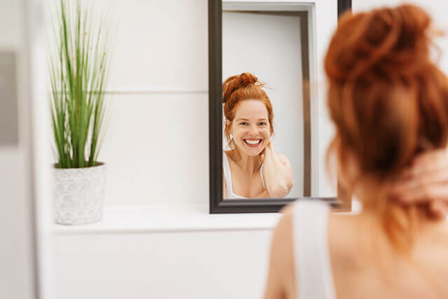 woman smiling in mirror