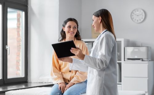 doctor shows smiling patient something