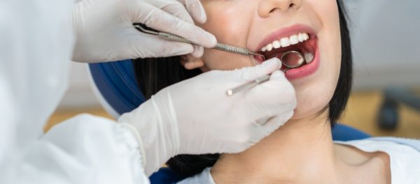 close up of dentist performing dental exam