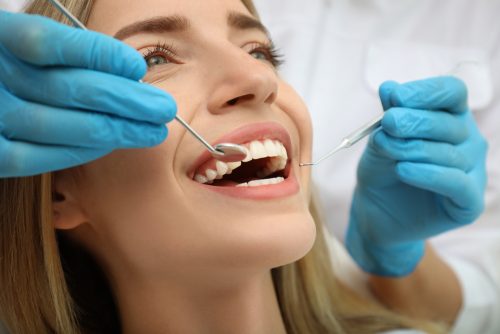 close up of a blonde woman getting a dental exam